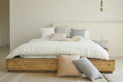 Aria solid oak platform bed in a warm minimalist bedroom